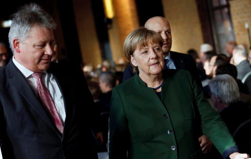 German Chancellor Angela Merkel,right, and the President of the German Federal Intelligence Agency (BND) Bruno Kahl attend a ceremony for the 60th anniversary of the founding of the BND in Berlin, Germany, Monday Nov. 28, 2016. (Hannibal Hanschke/Pool Photo via AP)