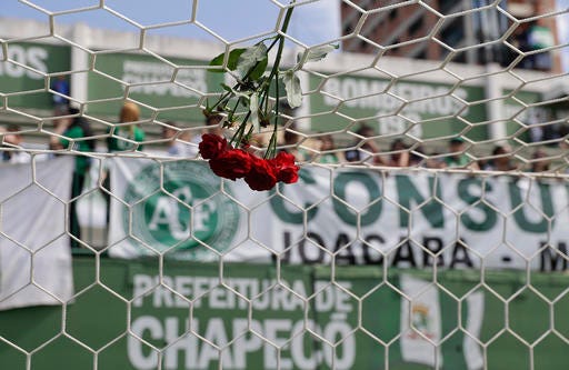 Flowers hang from a soccer net at the Arena Conda stadium where fans of the Brazilian soccer team Chapecoense began gathering, in Chapeco, Brazil, Tuesday, Nov. 29, 2016. A chartered plane that was carrying the Brazilian soccer team to the biggest match of its history crashed into a Colombian hillside and broke into pieces, Colombian officials said Tuesday. (AP Photo/Andre Penner)
