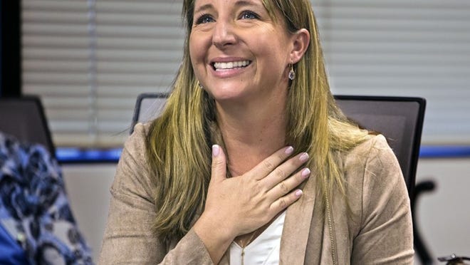 Christina Theiss, who is receiving an award for diving into a rip tide to save two struggling kids, talks about her experience at a Red Cross gathering where she was awarded the American Red Cross National Certificate of Merit for her actions. (Lannis Waters / The Palm Beach Post)