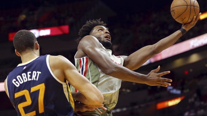 Miami Heat's Justise Winslow, right, shoots over Utah Jazz's Rudy Gobert (27) during the second half of an NBA basketball game, Saturday, Nov. 12, 2016, in Miami. (AP Photo/Lynne Sladky)
