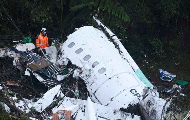 Rescue workers search at the wreckage site of a chartered airplane that crashed outside Medellin, Colombia, Tuesday, Nov. 29, 2016.