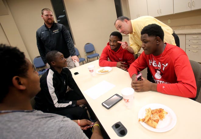 Shelby Police Chief Jeff Ledford chats with Cleveland County football players at Bridging the Gap. Brittany Randolph/The Star