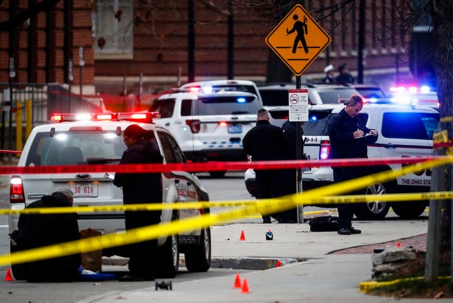 In this Nov. 28, 2016 file photo, crime scene investigators collect evidence from the pavement as police respond to an attack on campus at Ohio State University, in Columbus, Ohio. In chillingly detailed articles in a slick online magazine, Islamic State extremists exhorted English-language readers this fall to carry out attacks with knives and vehicles. Using those very methods, Somali-born student Abdul Razak Ali Artan injured multiple people in the attack at Ohio State University, authorities say.