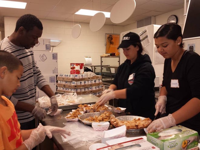 Volunteers prepare meals at Bread of Life's annual "Don't Be Alone on Thanksgiving" dinner at Malden High School on Thursday, Nov. 24. Courtesy photo