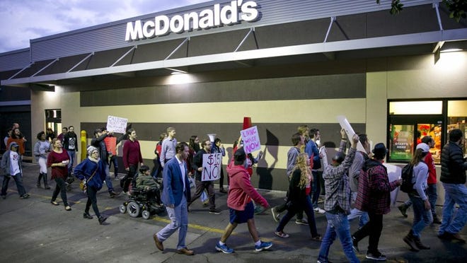 Fast food workers and supporters chant as they march around a McDonald’s restaurant on East Riverside Drive in Austin on Tuesday Nov. 29, 2016. JAY JANNER / AMERICAN-STATESMAN