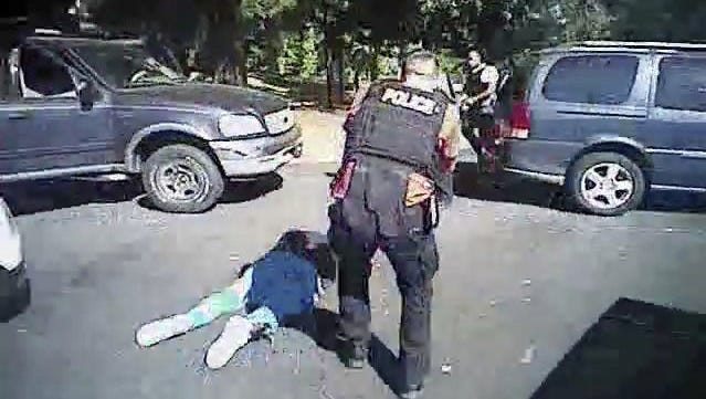This image made from video provided by the Charlotte-Mecklenburg Police Department on Saturday, Sept. 24, 2016 shows Keith Scott on the ground as police approach him in Charlotte, N.C., on Sept. 20, 2016. (Charlotte-Mecklenburg Police Department via AP)
