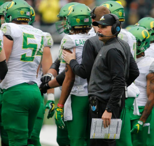 FILE- In this Nov. 26, 2016, file photo, Oregon head coach Mark Helfrich looks on in the first half an NCAA college football game against Oregon State, in Corvallis, Ore. Oregon's 34-24 loss to the Oregon State Beavers in the 120th Civil War has thrown coach Mark Helfrich's future with the team in doubt, as well as the direction of the program. Just moments after the Ducks left the field at Oregon State, Helfrich was asked about his job security. (AP Photo/Timothy J. Gonzalez, file)