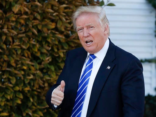 FILE - In this Nov. 19, 2016, file photo, President-elect Donald Trump gives the thumbs-up as he arrive at the Trump National Golf Club Bedminster clubhouse in Bedminster, N.J. Trump, ethics attorneys and good-government groups are all grappling with how to navigate being a president with extraordinary international and domestic business ties. While others in government are bound by rules and regulations about their business ties, the president has fewer such restrictions. (AP Photo/Carolyn Kaster, File)