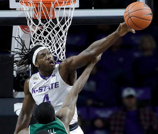 Kansas State's D.J. Johnson (4) blocks a shot by Green Bay's Khalil Small during the first half of an NCAA college basketball game Wednesday, Nov. 30, 2016, in Manhattan, Kan. (AP Photo/Charlie Riedel)