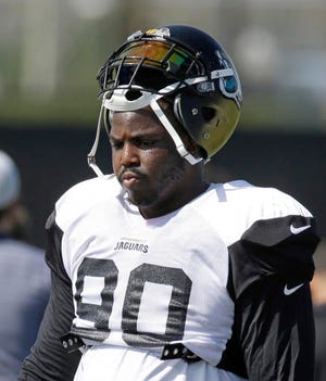 FILE - In this Wednesday, Aug. 3, 2016 file photo, Jacksonville Jaguars defensive tackle Malik Jackson takes a break during NFL football training camp in Jacksonville, Fla. Jackson left the Super Bowl champions to sign a six-year, $85.5 million contract with Jacksonville in free agency. As far as the Jaguars are concerned, Jackson has been worth the hefty price tag. The Jaguars play the Denver Broncos on Sunday, Dec. 4, 2016. (AP Photo/John Raoux, File)