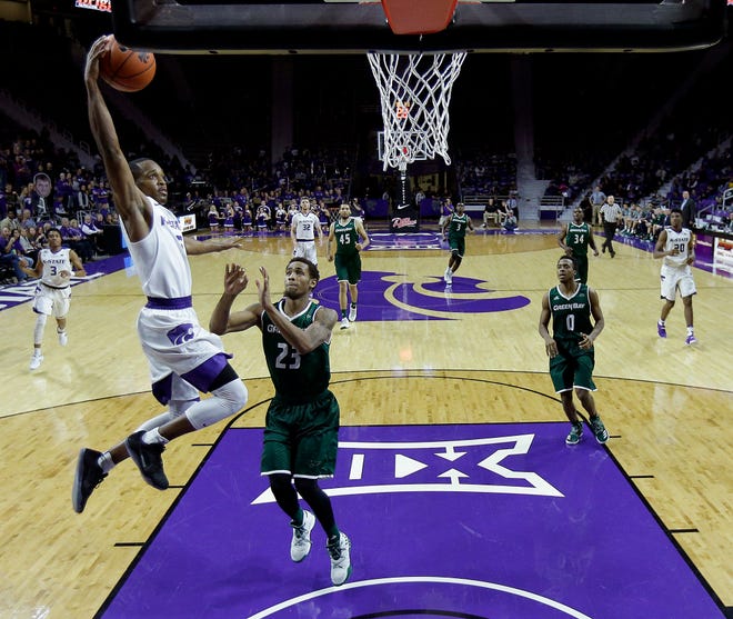Kansas State’s Barry Brown (5) gets past Green Bay’s Jamar Hurdle (23) to dunk the ball during the second half of an NCAA college basketball game Wednesday, Nov. 30, 2016, in Manhattan, Kan. Kansas State won 80-61. (AP Photo/Charlie Riedel)