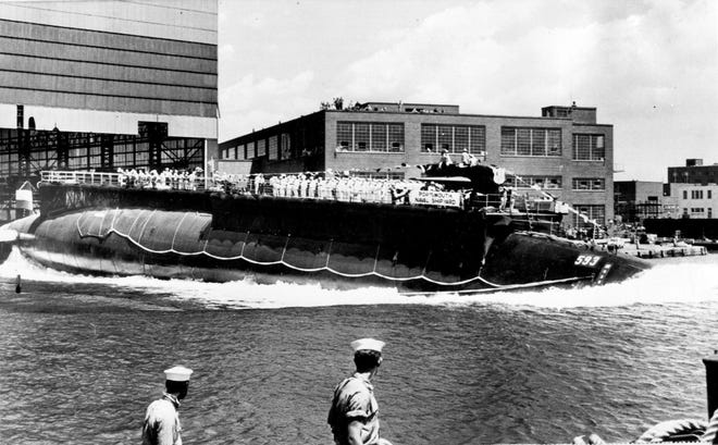 FILE - In this July 9, 1960 file photo the 278-foot (82 meters) long nuclear powered attack submarine USS Thresher, a first in its class boat, is launched bow-first at the Portsmouth Navy Yard in Kittery, Maine. A Navy submarine that left a Connecticut base this week is carrying the ashes of a veteran to be buried at sea near the site of the USS Thresher's sinking. For half a century Navy Capt. Paul "Bud" Rogers struggled with feelings that it should have been him and not his last-minute replacement on the doomed voyage. (AP Photo, File)