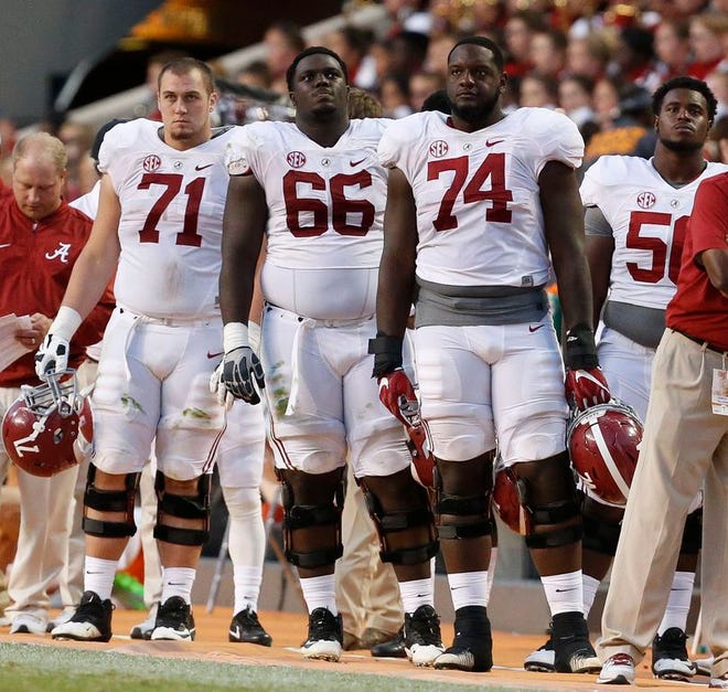 Alabama offensive linemen Ross Pierschbacher (71), Lester Cotton (66) and Cam Robinson (74) watch from the sidelines late in the Crimson Tide's game with Tennessee earlier this season.