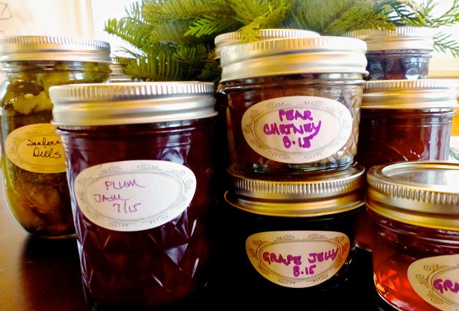 This Nov. 22, 2016 photo shows an assortment of jarred preserves, fruits and pickles in Langley, Wash., which are homegrown edibles exchanged as holiday gifts. Labels add a personal touch and in many cases include the ingredients as well as suggestions about how the foods should be used. Gardeners make good friends, especially during the holidays, as they share their homegrown harvest. (Dean Fosdick via AP)