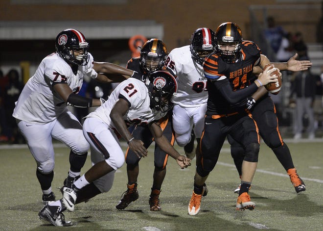 Beaver Falls quarterback Austin French darts away from Aliquippa's Soulvauhn Moreland (75) and Deonte Jones (21) during Friday night's game at Geneva College. French, who transferred to Aliquippa from Ambridge, has thrown for more than 800 yards and 10-plus touchdowns this season.
