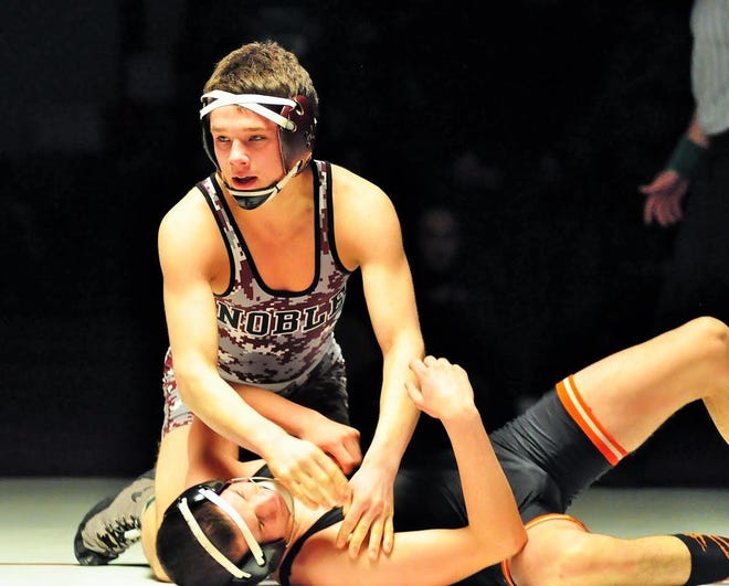 Noble senior Jake Martel, top, is seen here last winter after pinning Skowhegan's Samson Sirois for the Class A 126-pound state title. Martel will help the Knights contend against in Class A. Mike Whaley/Fosters.com