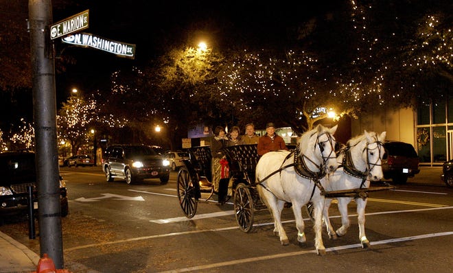 A carriage ride passes through the intersection of Marion and Washington streets around the court square in uptown Shelby. Carriage rides will begin at 5:30 p.m. Friday. STAR FILE PHOTO