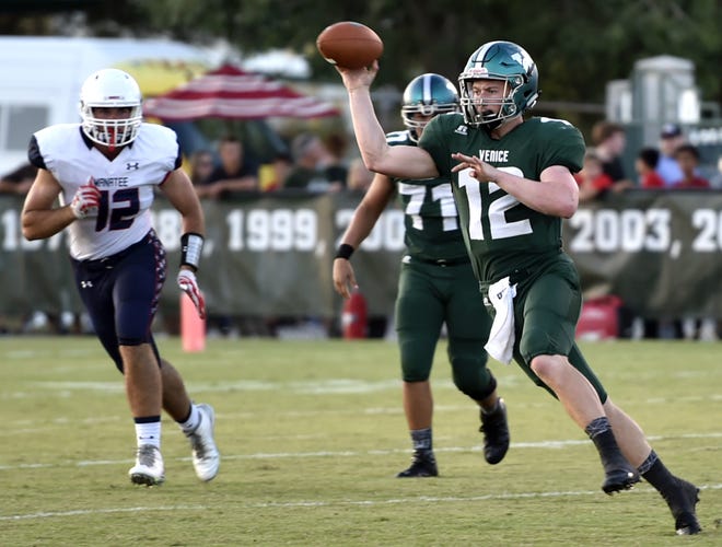 Venice's High quarterback (12) Bryce Carpenter completes a pass against Manatee High earlier this season. Carpenter is in charge of running the Indians no-huddle offense this season. Herald-Tribune staff photo / Thomas Bender