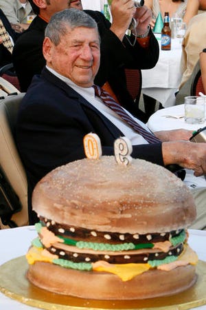 In this 2008, file photo, Big Mac creator Michael "Jim" Delligatti sits behind a Big Mac birthday cake at his 90th birthday party in Canonsburg, Pa. Delligatti, the Pittsburgh-area McDonald's franchisee who created the Big Mac in 1967, has died. He was 98.