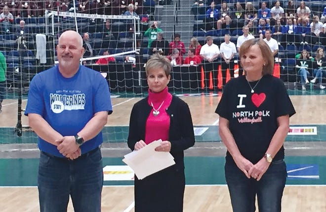 Lori Cory (far right) is standing with a representative from the IGHSAU (middle) and the sportsmanship recipient from the opposing school (Dike-New Hartford) during the award ceremony.