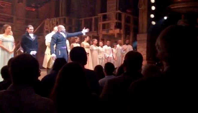 In this image made from a video provided by Hamilton LLC, actor Brandon Victor Dixon who plays Aaron Burr, the nation’s third vice president, in "Hamilton" speaks from the stage after the curtain call in New York, Friday, Nov. 18, 2016. Vice President-elect Mike Pence is the latest celebrity to attend the Broadway hit "Hamilton," but the first to get a sharp message from a cast member from the stage.