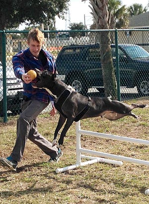 Ryan Heinz plays with his brother’s dog Jackson at Paws Dog Park in 2014. (The Florida Times-Union)