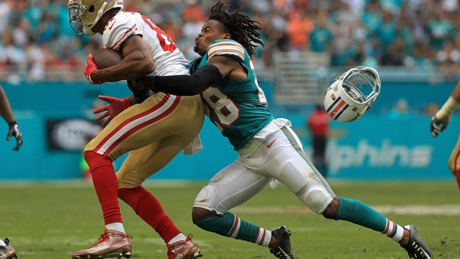 MIAMI GARDENS, FL - NOVEMBER 27: Bobby McCain #28 of the Miami Dolphins tackles Rod Streater #81 of the San Francisco 49ers during a game on November 27, 2016 in Miami Gardens, Florida. (Photo by Mike Ehrmann/Getty Images)