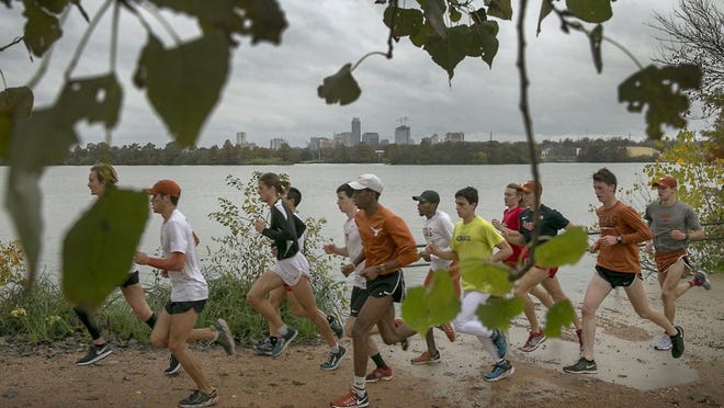 Showers have continued throughout the day Sunday, but the cold, wet and gloomy weather did not deter people from venturing outside for their normal activities. This large group of runners from the University of Texas went for a run Sunday afternoon near Lady Bird Lake on the east end along Pleasant Valley Road.