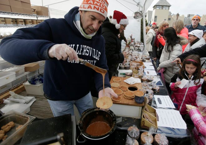 Photo by Jake West/New Jersey Herald - Jonathan Groff makes Stroopies, a traditional Dutch dessert, on Saturday during the Lake Mohawk German Christmas Market, on the Lake Mohawk Boardwalk in Sparta.
