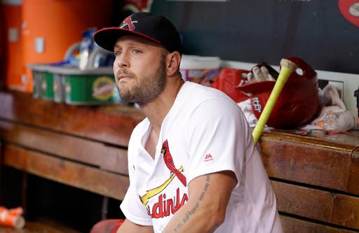 FILE - In this Oct. 2, 2016, file photo, St. Louis Cardinals left fielder Matt Holliday sits in the dugout after leaving a baseball game against the Pittsburgh Pirates during the ninth inning in St. Louis. A person familiar with the negotiations says free agent Holliday and the New York Yankees have agreed to a $13 million, one-year contract. The person spoke on condition of anonymity Sunday night, Dec. 4, 2016, because the agreement had not yet been announced. (AP Photo/Jeff Roberson, File)