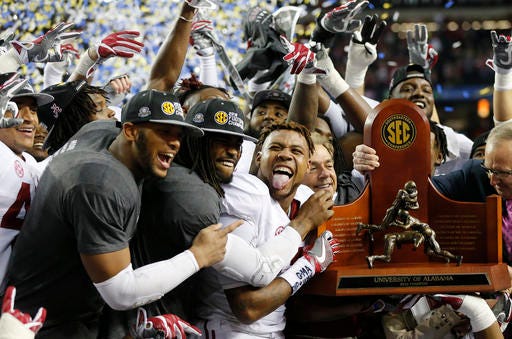 Alabama team members celebrate after the Southeastern Conference championship NCAA college football game against Florida, Saturday, Dec. 3, 2016, in Atlanta. Alabama won 54-16. (AP Photo/John Bazemore)