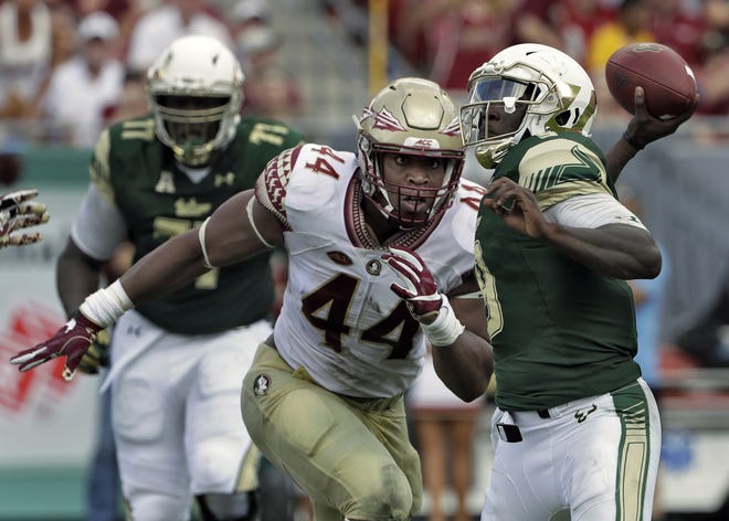 In this Sept. 24, 2016, file photo, Florida State defensive end DeMarcus Walker (44) closes in on South Florida quarterback Quinton Flowers as he throws a pass during the second half of a college football game, in Tampa. The 6-4, 280-pound DE leads the nation with 10.5 sacks to match his total from last year and has three forced fumbles. THE ASSOCIATED PRESS / CHRIS O'MEARA