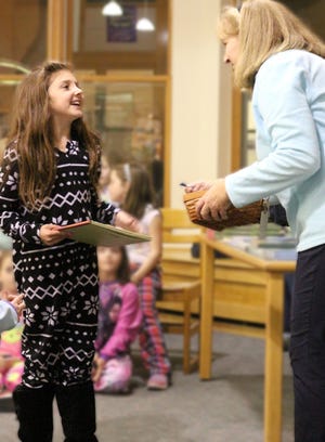 Louise Burns, literacy coordinator for Noble Adult & Community Education, greets Lexi Damon at the recent Pajama Party at Noble High School. Photo/Courtesy