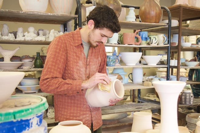 Alex Stewart works in the Gardner-Webb University art studio. Stewart, who will graduate next year, compares creating pottery to working in discipleship. PHOTO BY MARK HOUSER/GARDNER-WEBB UNIVERSITY.