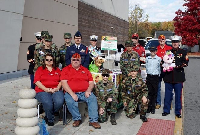 Pictured are Civil Air Patrol Cadets Cates, DiPasquale, Beutler, Head, Fox, Heckle, VanGundy, Caudle and S. VanGundy assisting members of the Marine Corps League with collections for Toys For Tots. Special to The Gazette.