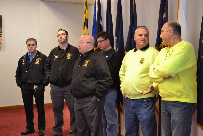 Members of the Teamsters 251 union stand in the back of the Fall River Room as Mayor Jasiel Correia II announced plans to privatize trash services on April 12.