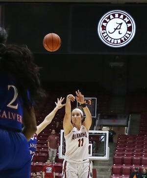 Alabama's Hannah Cook (11) shoots to score 3 points from the top of the key to tie the game 56-56 at the end of regulation play against the University of Kansas at Coleman Coliseum in Tuscaloosa on Sunday. Alabama defeated the Jayhawks 71-65 in overtime.  Staff Photo/Erin Nelson