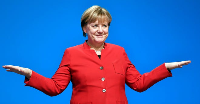 German Chancellor and Chairwomen of the CDU, Angela Merkel, gestures after her speech as part of a general party conference of the Christian Democratic Union (CDU) in Essen, Germany, Tuesday, Dec. 6, 2016. Merkel wants to secure the backing of her conservative party to head up the party’s campaign for next September’s election. (AP Photo/Martin Meissner)