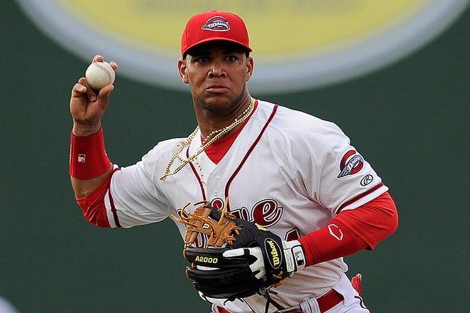 Second baseman Yoan Moncada (24) of the Greenville Drive throws out a runner in a game against the Lexington Legends on Monday, May 18, 2015, at Fluor Field at the West End in Greenville, South Carolina. Moncada, a 19-year-old prospect from Cuba, made his professional debut tonight in the Red Sox organization.