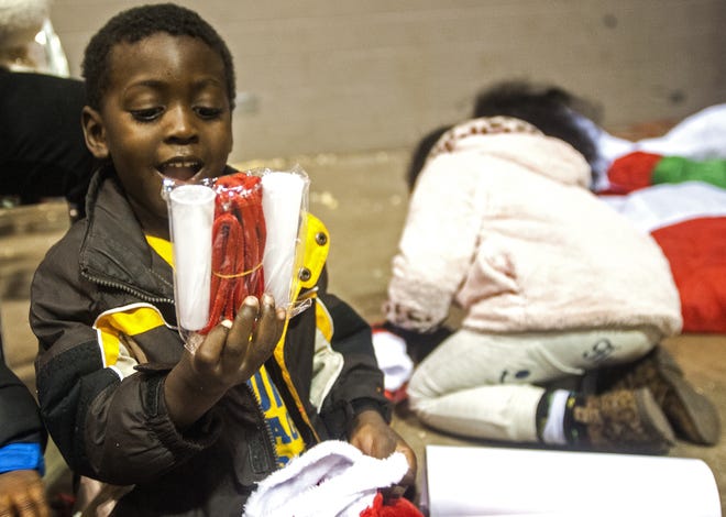 LEWIS MARIEN/JOURNAL STAR

Tylen Muhammad-Daniel, 3, flashes a smile at one of his items he got in his stocking Tuesday during the Journal Star and Salvation Army's Red Stocking/Share the Spirit Party at the Peoria Civic Center.