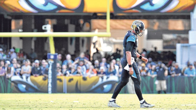 Blake Bortles walks to the sideline Sunday against Denver after getting up slowly when he landed on his shoulder. (Bruce Lipsky/Florida Times-Union)