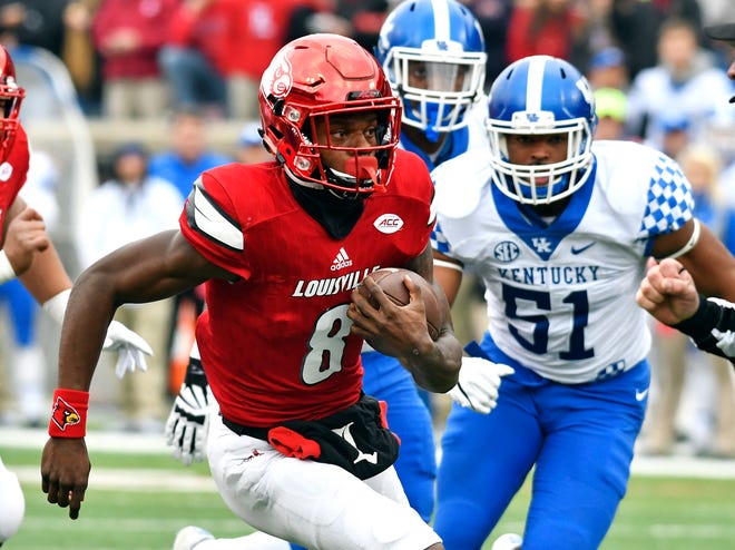 Louisville’s Lamar Jackson (8) attempts to get away from the pursuit of Kentucky’s Vourtney Love (51) during the first half Nov. 26 in Louisville, Ky. Jackson is one of five finalists for the Heisman Trophy. (AP Photo/Timothy D. Easley)