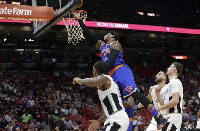 Knicks' Carmelo Anthony drives to the basket to score two of his game-high 35 points Tuesday night in Miami. The Associated Press