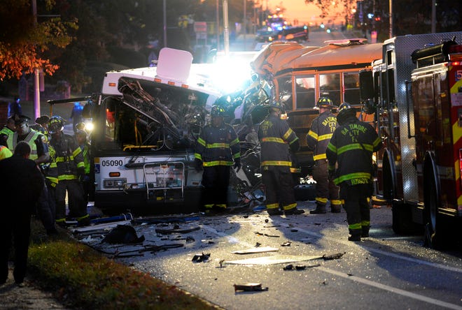FILE - In this Tuesday, Nov. 1, 2016, file photo, fire department and rescue officials work at the scene of an early morning fatal collision between a school bus and a commuter bus in Baltimore. National investigators said the driver of the Baltimore school bus, Glen Chappell, that careened into a transit bus, killing six people, including himself, was speeding and had a history of crashes and seizures, in its initial report Wednesday, Dec. 7. (Jeffrey F. Bill/The Baltimore Sun via AP, File)