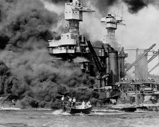 In this Dec. 7, 1941 photo made available by the U.S. Navy, a small boat rescues a seaman from the USS West Virginia burning in the foreground in Pearl Harbor, Hawaii, after Japanese aircraft attacked the military installation. A few dozen survivors of the Japanese attack on Pearl Harbor plan to gather in Hawaii, Wednesday, Dec. 7, 2016, to remember those killed 75 years ago. (U.S. Navy via AP, File)
