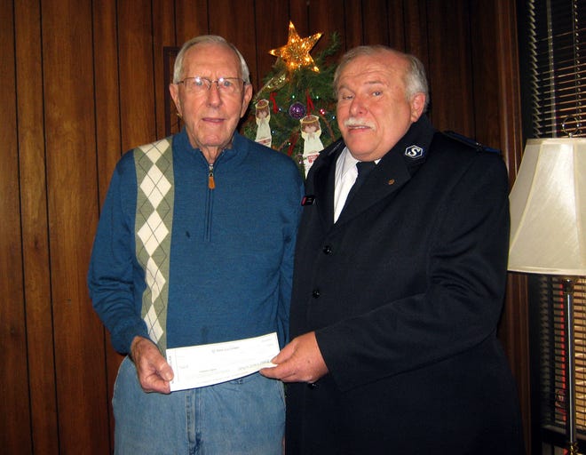 The $3,069 donation given by Reid Sipe, of Kings Mountain, to Sgt. Les Ashby of The Salvation Army represents his yearlong effort of repairing clocks. Sipe’s annual donation comes in memory of his wife and grandson. Cassie Tarpley/Special to The Star