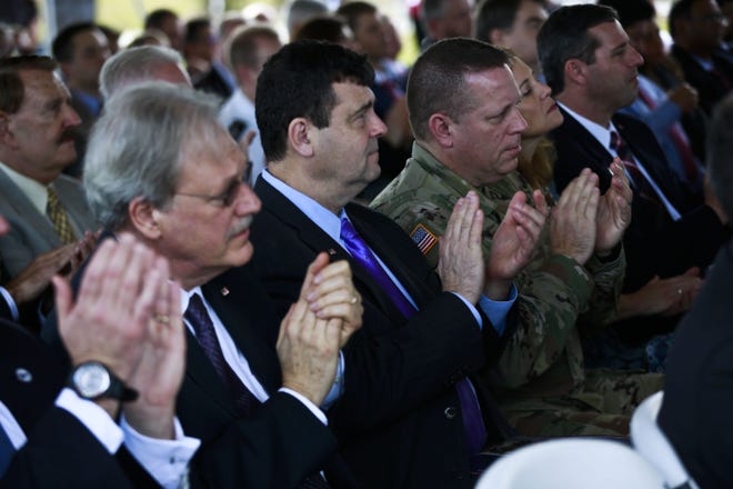 Audience members applaud during the ribbon-cutting for the U.S. Department of Defense Advanced Development and Manufacturing Facility in Alachua, Fla., Dec. 7, 2016. The DoD ADM was designed to incorporate technological advances in disposable manufacturing equipment while also producing a multi-product capability that reduces overall costs and time necessary to change out product lines. (Andrea Cornejo/Staff photographer)