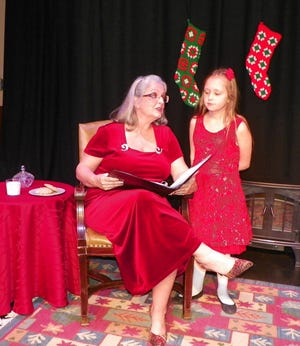 Cathy Frahme reads a Christmas story to Ella Carroll. PAT DE MONO/FOR THE GAZETTE