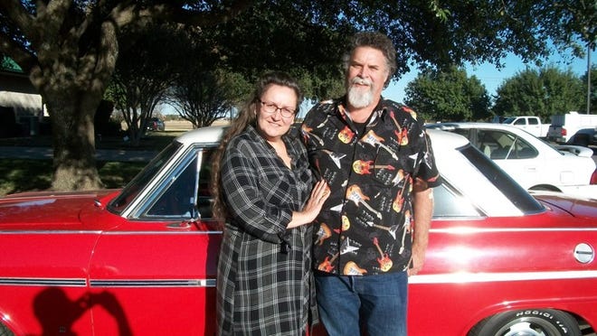 Randy Rodgers and wife Marlana stand next to his 1963 Chevy Nova, one of the cars Rodgers plans to work on in his retirement. Photo by Brad Stutzman