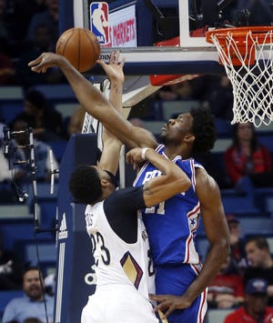 Sixers center Joel Embiid blocks a shot by New Orleans Pelicans forward Anthony Davis in the first half of Thursday's game in New Orleans.